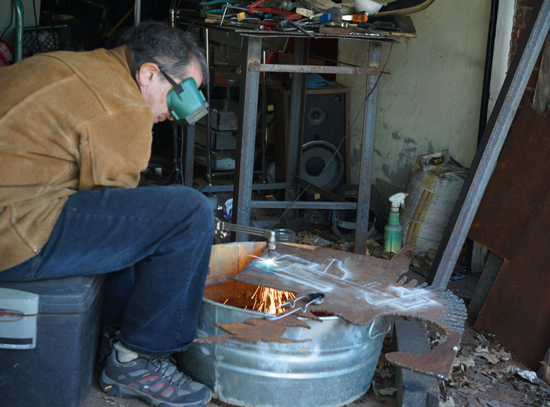 Artist Cutting Steel Bird