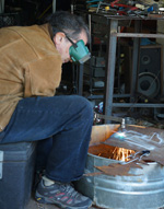 Artist Cutting Steel Bird